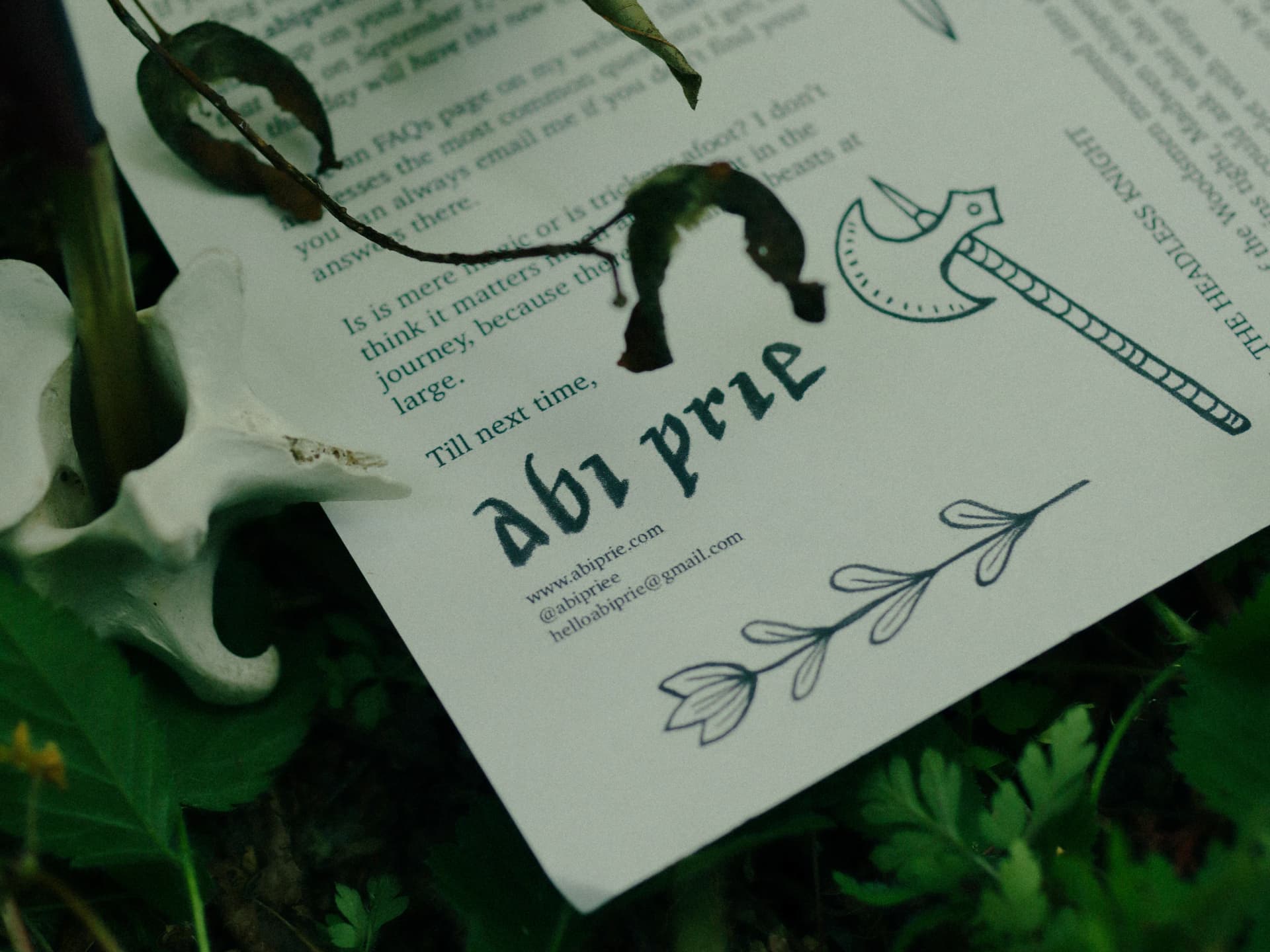 Headless Knight letter for abi.prie resting on moss beside a weathered animal skull